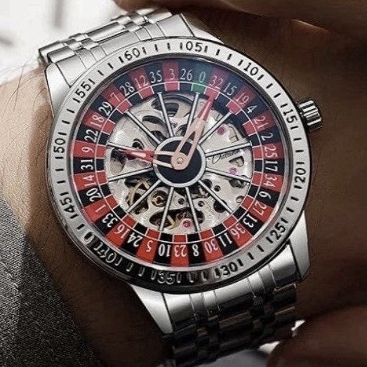 Silver wristwatch with a detailed face on a person's wrist