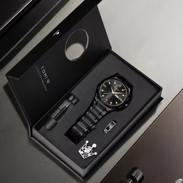 Black watch with accessories in a branded box on a gray surface